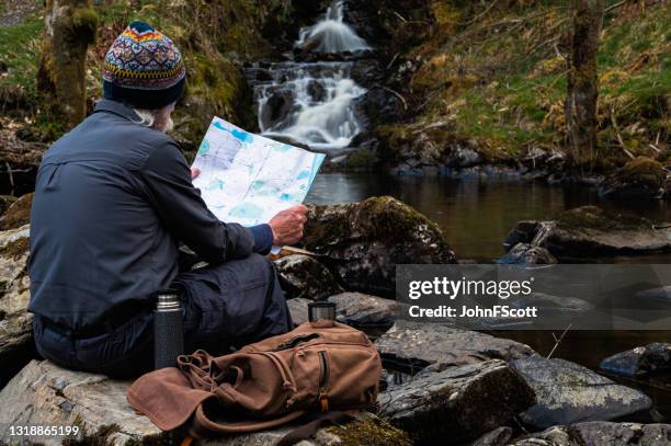 active retired man checking his map - tourist map stock pictures, royalty-free photos & images