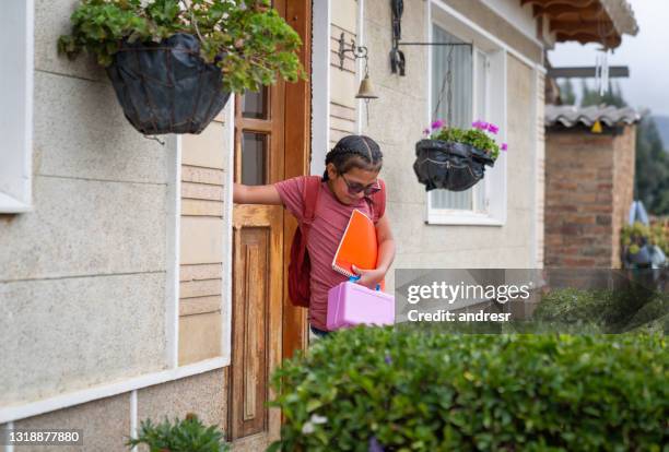 latin american girl leaving the house to go to school - school closing stock pictures, royalty-free photos & images