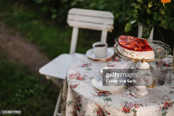 garden table with teacups, teapot and strawberry cake on - paradise jam stock pictures, royalty-free photos & images