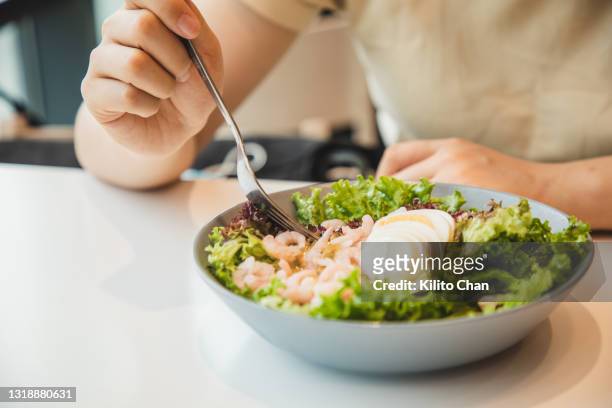 enjoying a bowl of healthy fresh salad - hard boiled eggs stock pictures, royalty-free photos & images