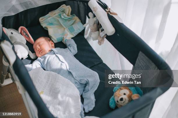 high angle view asian chinese baby boy sleeping in a crib - cot imagens e fotografias de stock