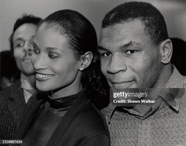 View of American model Beverly Johnson and heavyweight boxer Mike Tyson as the attend a performance in Harlem's Apollo Theater, New York, New York,...