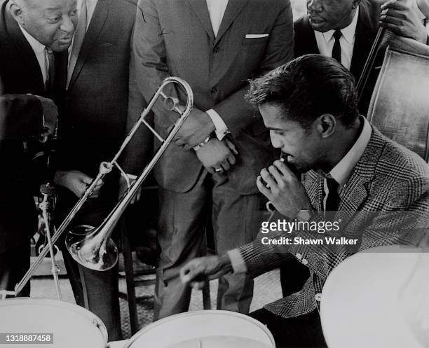 View of American musician and entertainer Sammy Davis Jr as he performs during an event near the intersection of 125th Street and 7th Avenue in...