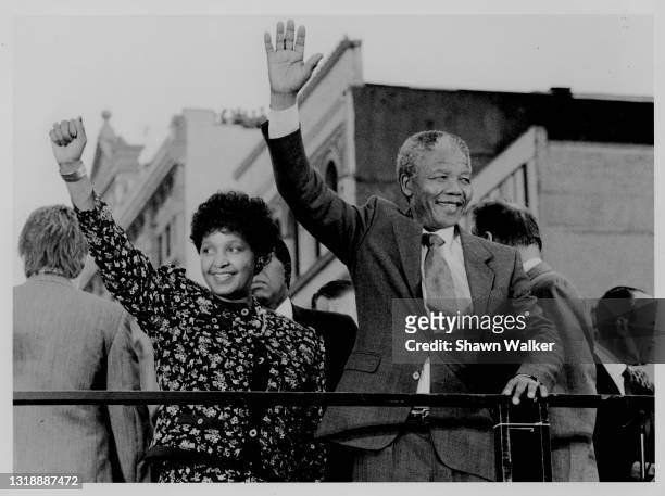 View of married South African anti-Apartheid activists Winnie Mandela and Nelson Mandela as they wave to supporters, near the intersection of 125th...