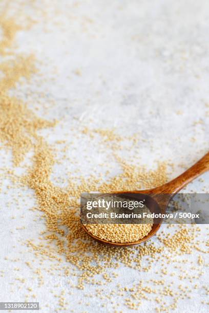 close-up of wooden spoon with seeds on table - amarant stock pictures, royalty-free photos & images