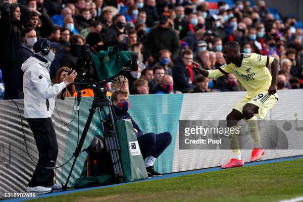 Nicolas Pepe of Arsenal celebrates in front of a TV camera after scoring his team's first goal during the Premier League match between Crystal Palace...