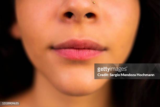 close-up of the mouth and nose of a young latino woman - taste test stock pictures, royalty-free photos & images