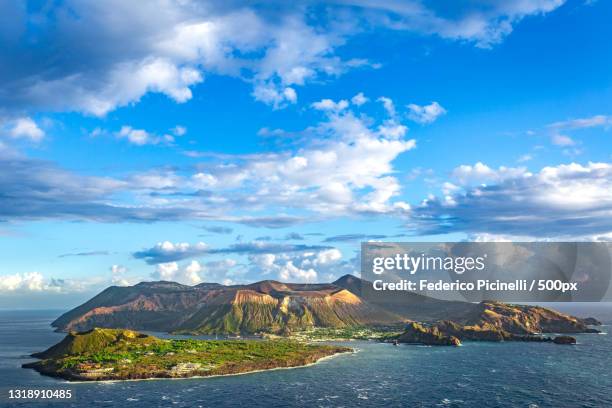 scenic view of sea and mountains against sky,lipari,messina,italy - messina stock pictures, royalty-free photos & images