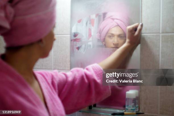 woman coming out of the bathroom - woman in mirror stock pictures, royalty-free photos & images