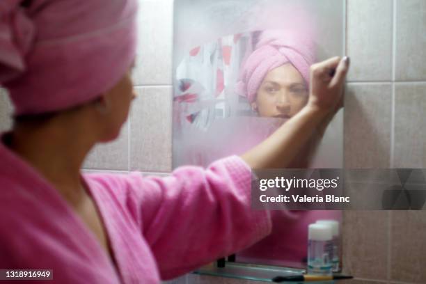 woman coming out of the bathroom - mirror steam stock pictures, royalty-free photos & images