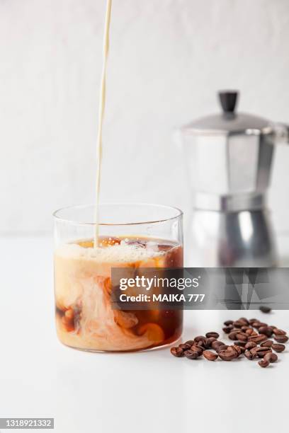 close-up of 'proffee' (protein and coffee) in a glass on white background - protein shake stock-fotos und bilder