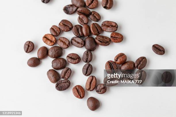 top view of coffee beans isolated on white background - bean stock-fotos und bilder