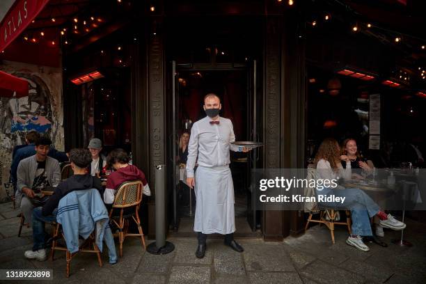 Waiter stands on the terrace at Atlas Restaurant in Paris' 6th Arrondissement as cafes and restaurants across France re-open for the first time in...