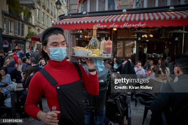 Waiter serves customers on the terrace at Bar du Marche in Paris' 6th Arrondissement as cafes and restaurants across France re-open for the first...