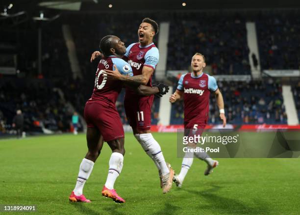Michail Antonio of West Ham United celebrates with team mate Jesse Lingard after scoring his team's third goal during the Premier League match...