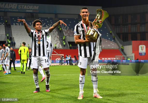 Cristiano Ronaldo of Juventus celebrates with the TIMVISION cup as Weston McKennie celebrates victory following the TIMVISION Cup Final between...