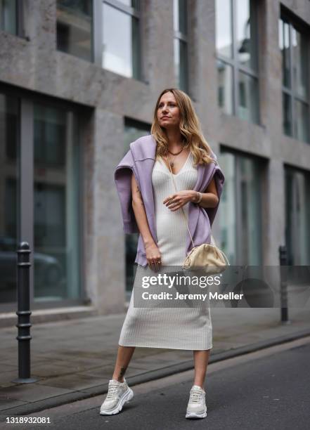 Michi Brandl wearing beige LeGer knit dress, beige Bottega Veneta leather bag, lilac Zara hoodie and sneakers by Copenhagen Studios on May 11, 2021...