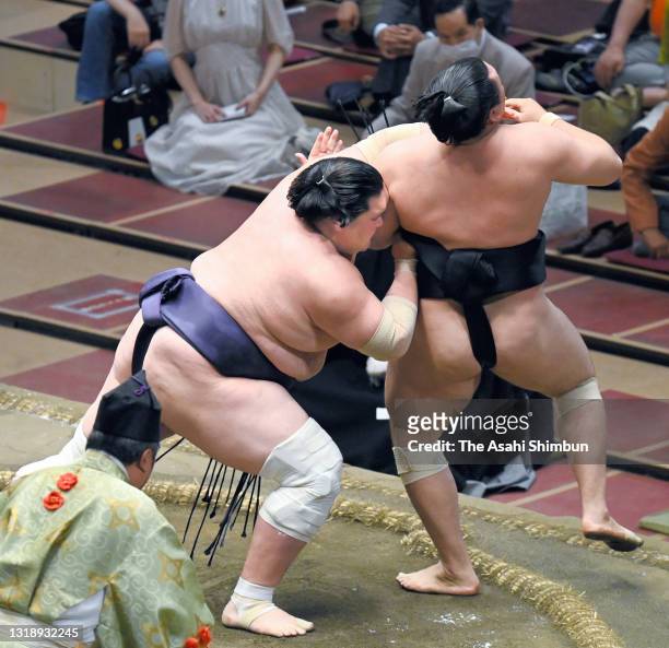 Ozeki Terunofuji sends Kiribayama out of the ring to win during day ten of the Grand Sumo Summer Tournament at Ryogoku Kokugikan on May 18, 2021 in...