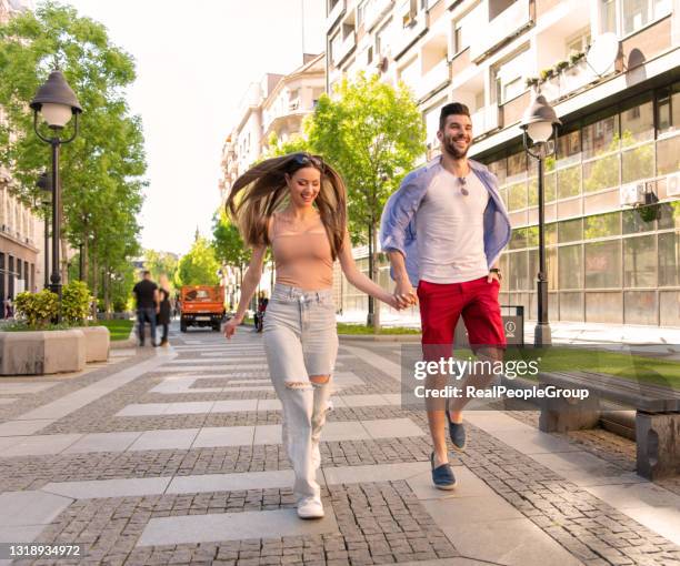 happy to be together. - woman walks down street stock pictures, royalty-free photos & images