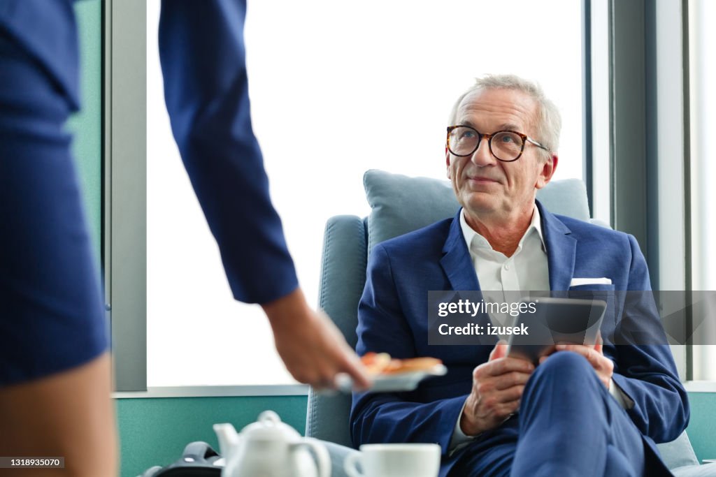Senior businessman at airport lounge