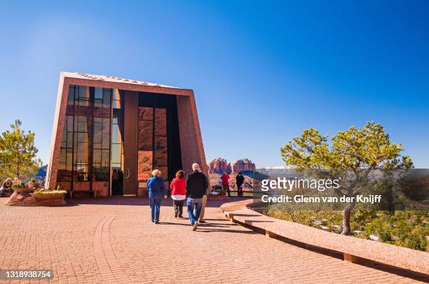 visitors entering the peculiar-designed chapel of the holy cross on a brilliant but cool winter's day, sedona, arizona - chapel of the holy cross sedona stock pictures, royalty-free photos & images