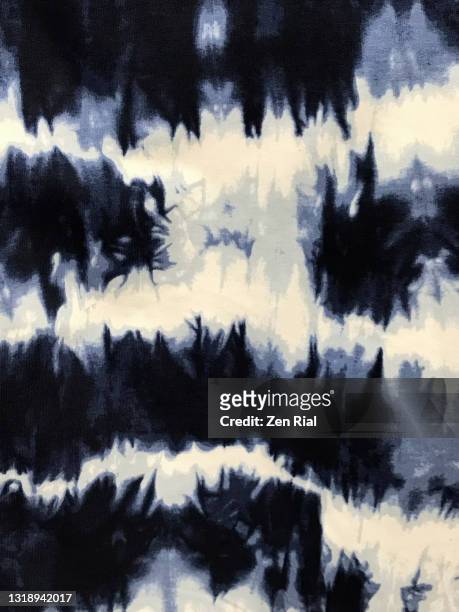 tie dye cotton t-shirt fabric of blue, black and gray colors on white background - teñido multicolor fotografías e imágenes de stock
