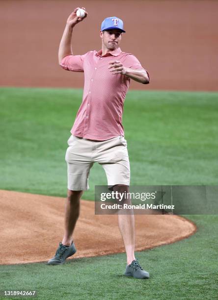 Tennis player, John Isner throws out the ceremonial first pitch before a game between the New York Yankees and the Texas Rangers at Globe Life Field...