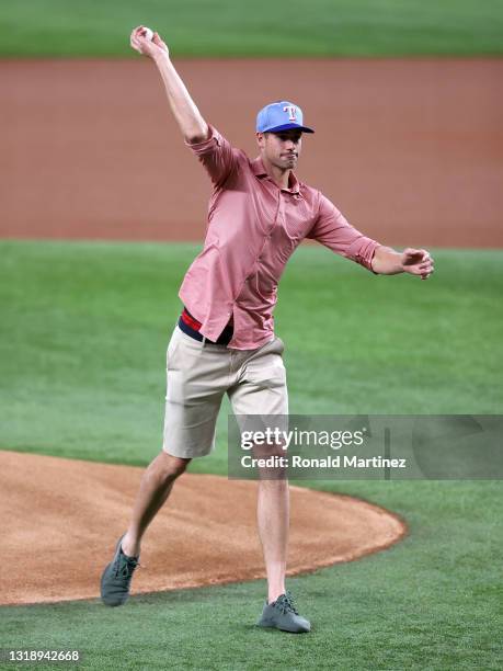 Tennis player, John Isner throws out the ceremonial first pitch before a game between the New York Yankees and the Texas Rangers at Globe Life Field...