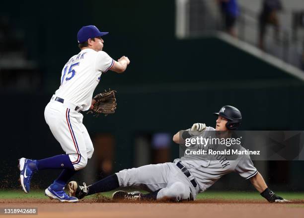 Nick Solak of the Texas Rangers turns the double play against DJ LeMahieu of the New York Yankees in the first inning at Globe Life Field on May 19,...