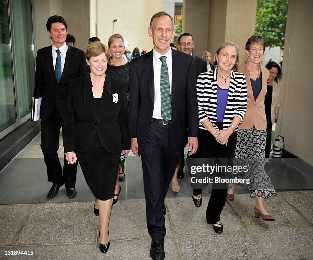 Bob Brown, Australian Greens party leader, center, and Christine Milne, deputy leader, second left, lead party members Scott Ludlam, senator for...