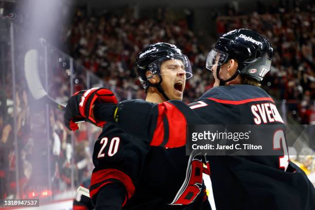 Sebastian Aho of the Carolina Hurricanes celebrates with teammate Andrei Svechnikov following a goal scored during the first period in Game Two of...