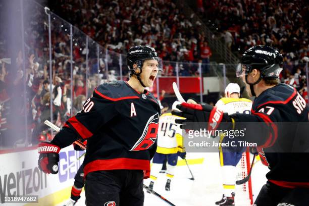 Sebastian Aho of the Carolina Hurricanes celebrates with teammate Andrei Svechnikov following a goal scored during the first period in Game Two of...