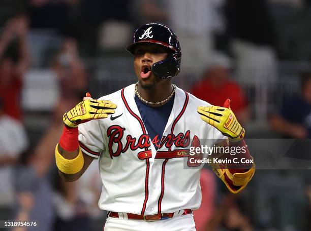 Ronald Acuna Jr. #13 of the Atlanta Braves reacts after hitting a walk-off homer in the ninth inning against the New York Mets at Truist Park on May...