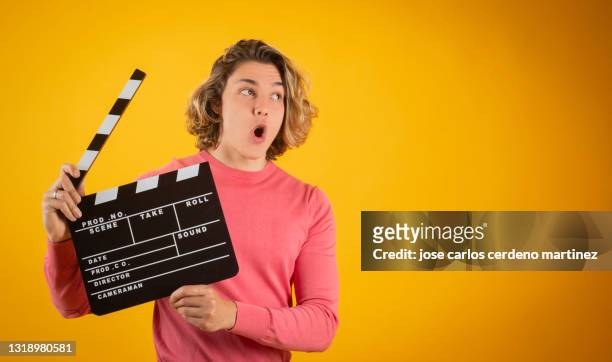 blond man clapperboard, smiling, movies - clapperboard stock pictures, royalty-free photos & images