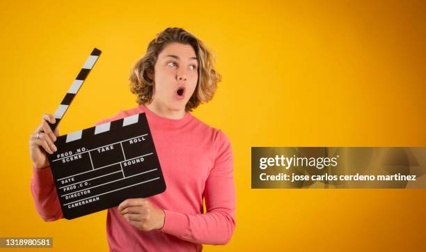 blond man clapperboard, smiling, movies - cinematografi bildbanksfoton och bilder