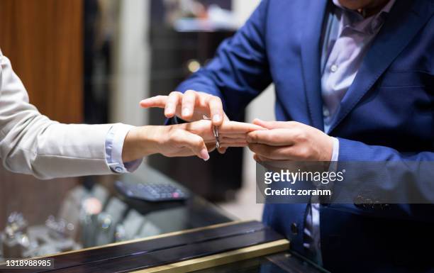 close-up on woman's hand, trying on luxurious jewelry - jeweller stock pictures, royalty-free photos & images