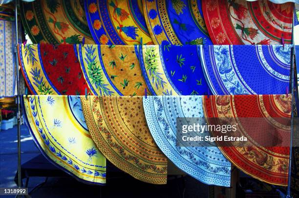 At an open air market in Roussillon, in the south of France, a stand offers a dazzling array of Provencal tablecloths, October 2000. Many of these...