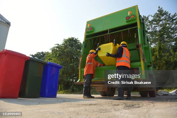 garbage collector worker of urban municipal recycling garbage collector truck loading waste - garbage truck stock-fotos und bilder