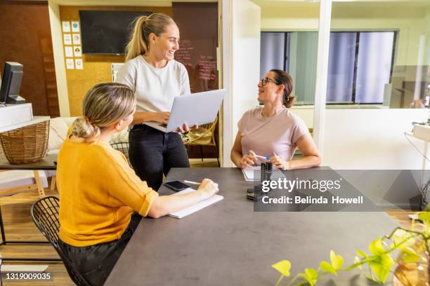 office workers work on computers and cooperate in a relaxed environment - project manager stock pictures, royalty-free photos & images