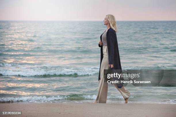 woman in sunset - female 40 year old beach stock pictures, royalty-free photos & images