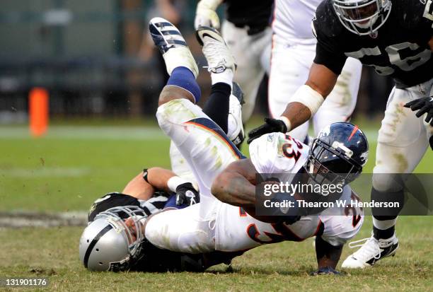 Willis McGahee of the Denver Broncos gets tackled by Matt Giordano of the Oakland Raiders at O.co Coliseum on November 6, 2011 in Oakland,...