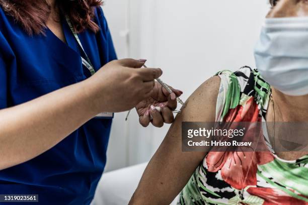 Medical worker injects COVID-19 vaccine to an empolyee of the Bulgarian Black Sea resort of Albena on May 20, 2021 in Albena, Bulgaria. Bulgaria...