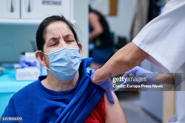 Health worker vaccinates a homeless woman at the Centro de Acogida Municipal Para Personas Sin Hogar San Isidro, on 20 May, 2021 in Madrid, Spain....