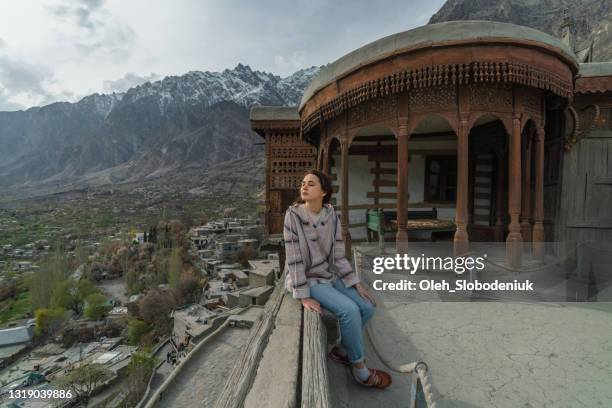 woman looking out of the balcony in fort - karimabad hunza stock pictures, royalty-free photos & images