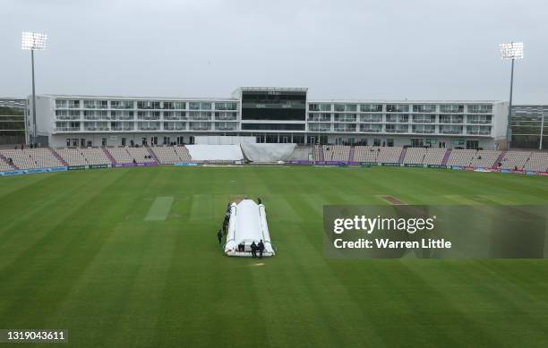 Grounds staff cover the wicket as rain delays the LV=Insurance County Championship match between Hampshire and Leicestershire at Ageas Bowl on May...