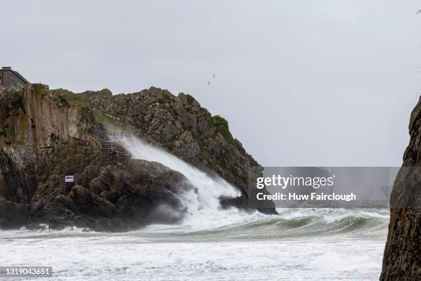 View of waves crashing on to St Catherine's Island and South Beach in high winds on May 20, 2021 in Tenby, Wales. The Met Office have issued a Yellow...