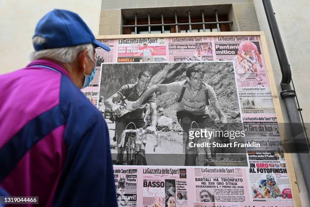 Fan looks a vintage image of Fausto Coppi & Gino Bartali taken during 1952 Tour de France, at finish Village Bagno di Romagna during the 104th Giro...