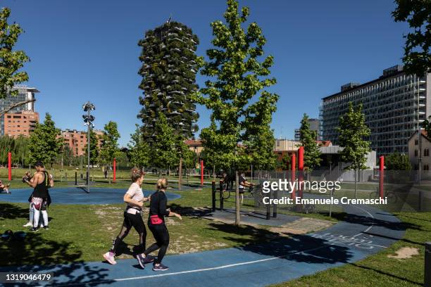 People exercise in front of the so called Bosco Verticale , a pair of residential towers designed by Italian architect Stefano Boeri and located in...