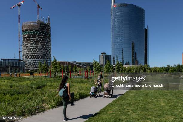 Two mothers attend a class held by a MammaFit fitness instructor at BAM - Biblioteca degli Alberi Milano, a public park located in the Porta Nuova...