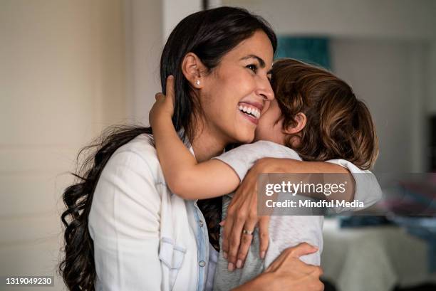 mother and son embracing each other at home - image of the week stock pictures, royalty-free photos & images